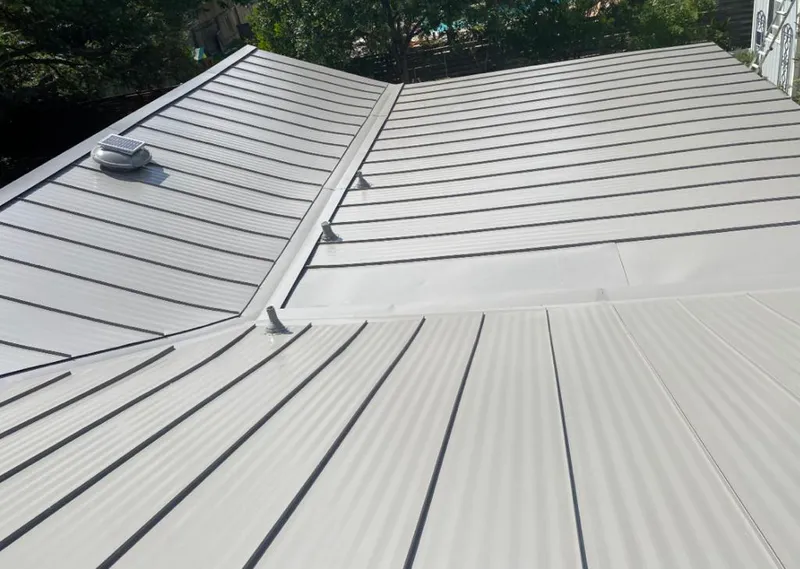 Solar attic fan installed on a metal roof for Roof Ventilation in International Falls